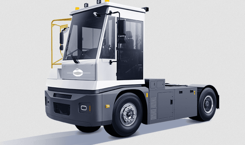 White and grey terminal tractor with a large glass cabin for moving trailers in ports.